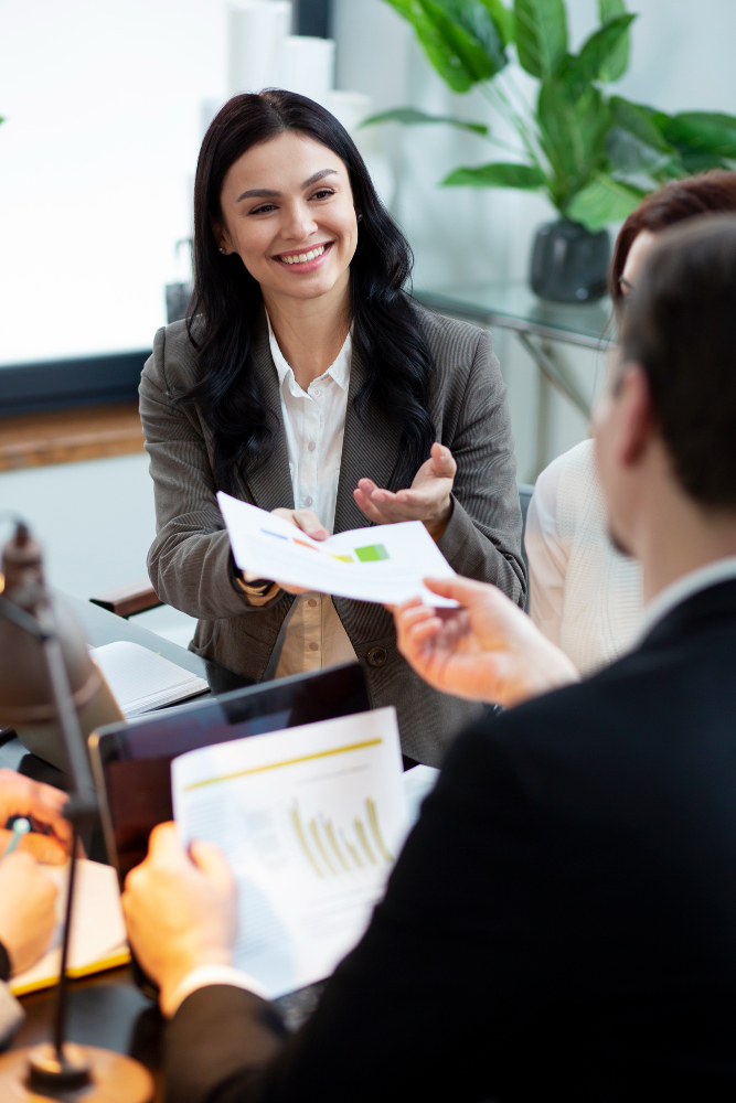 Smiling businesswoman sharing reports in a meeting, symbolizing effective employer review cleanup services