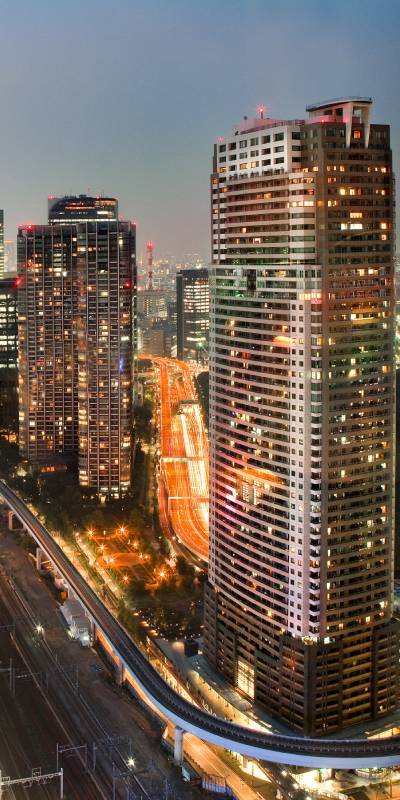 City skyline at night representing global reach of MGMT Reputation AI reputation management services