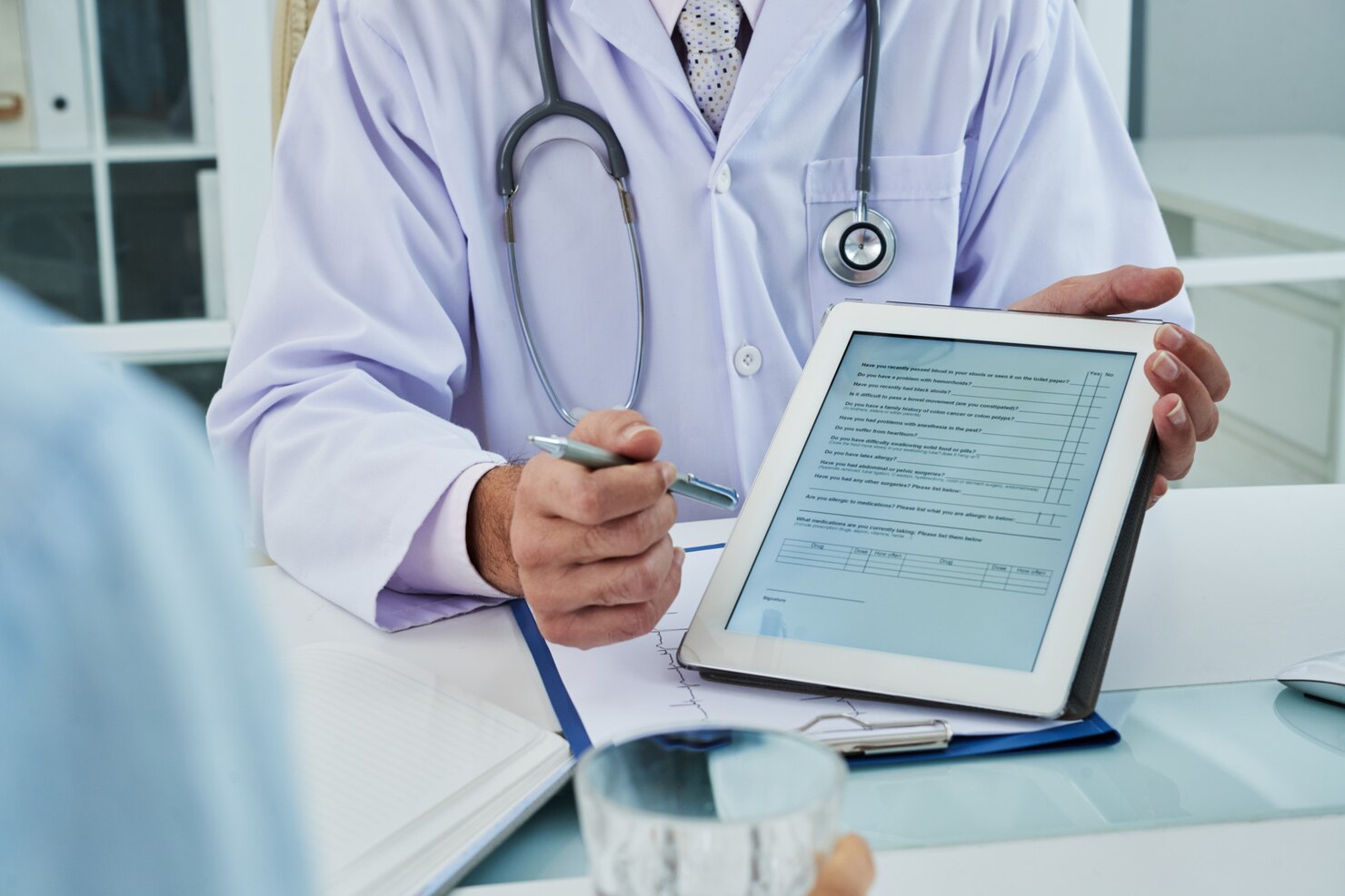 unrecognizable doctor extending digital tab anonymous patient fill questionnaire 1098 19318